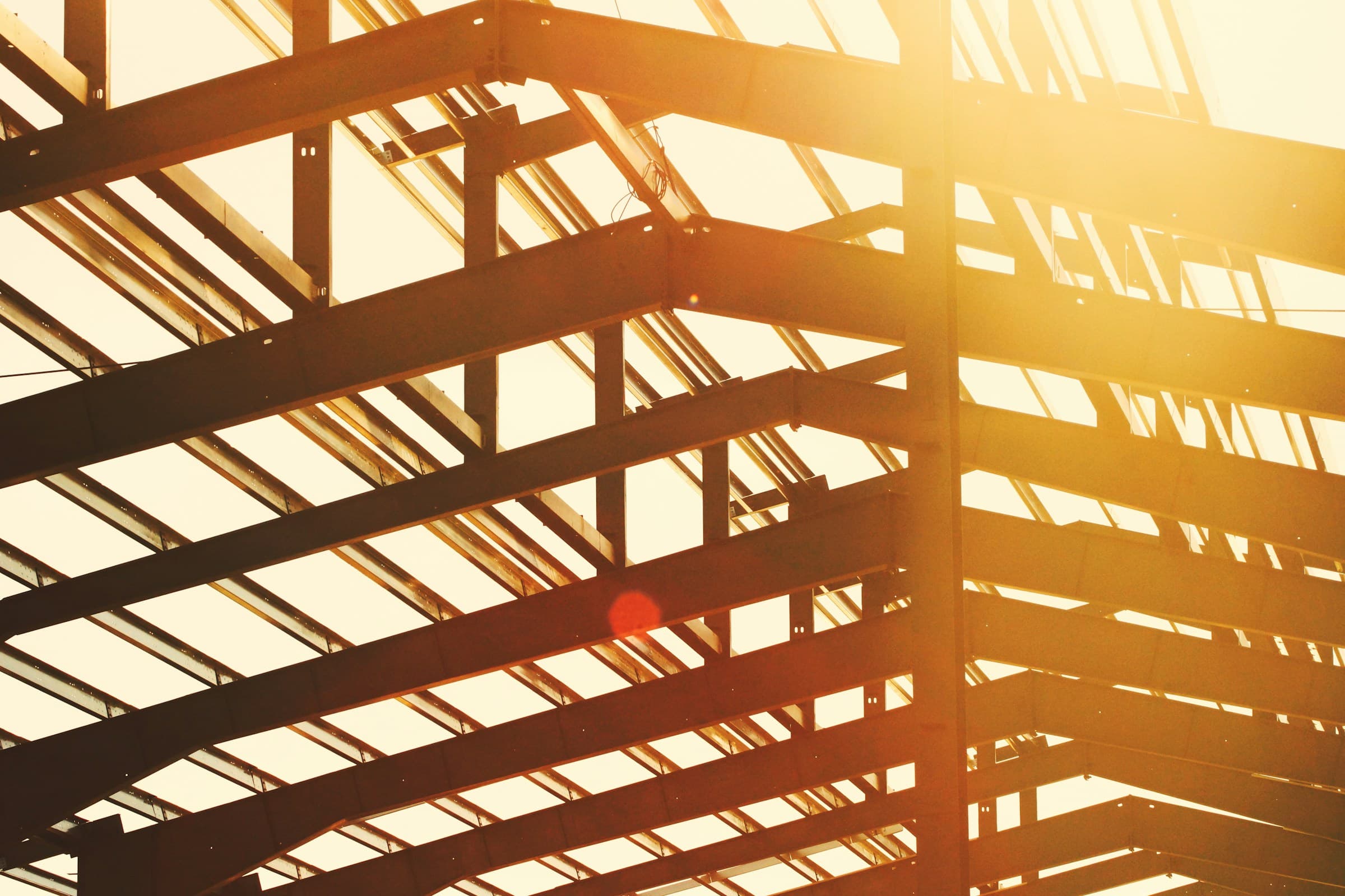 Backlit structural steel beams in an industrial frame